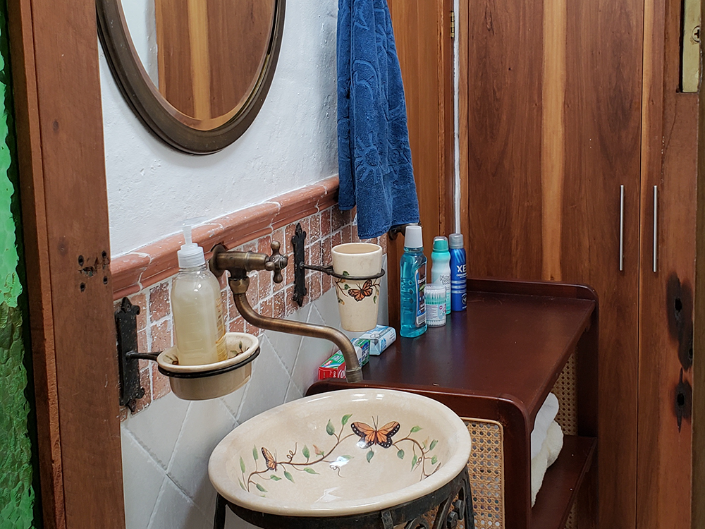 Quaint shared bathroom with large, hot water shower